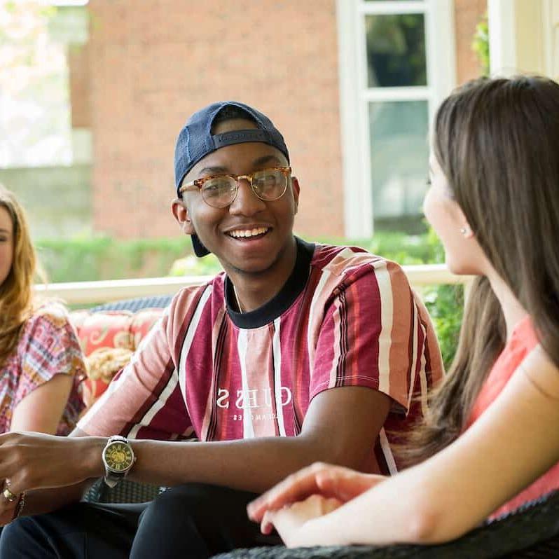 Students gather to socialize and talk on the porch of the President's House during the Creosote Affects photo shoot May 1, 2019 at Washington &amp; Jefferson College.